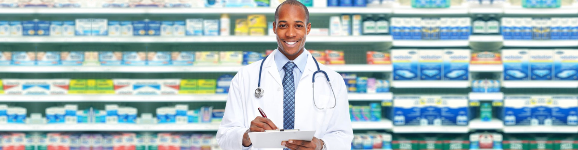 male pharmacist smiling while holding a form